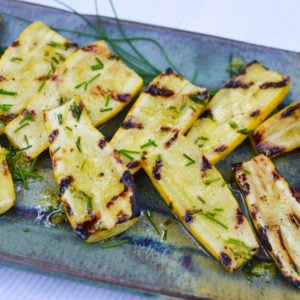 Fresh, yellow squash is grilled to perfection then drizzled with a bright, lemon chive vinaigrette for a delicious summer side dish.