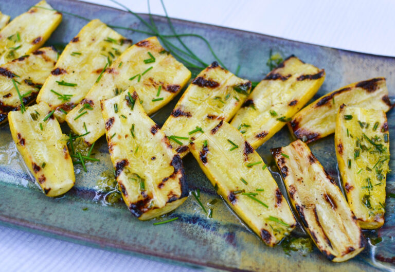 Fresh, yellow squash is grilled to perfection then drizzled with a bright, lemon chive vinaigrette for a delicious summer side dish.