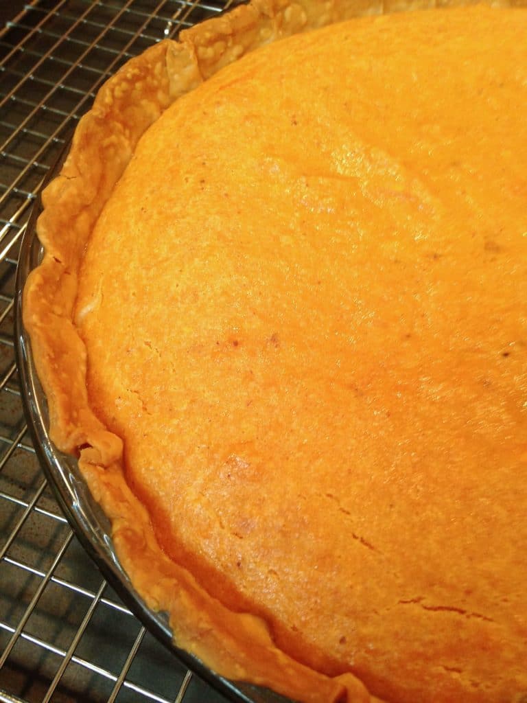 Sweet Potato Pie is a classic southern dessert that's easy to make. Store bought pie crust, sweet potatoes, warm spices and sweetened milk are all combined to make a delicious pie perfect for a weeknight meal or the holidays.