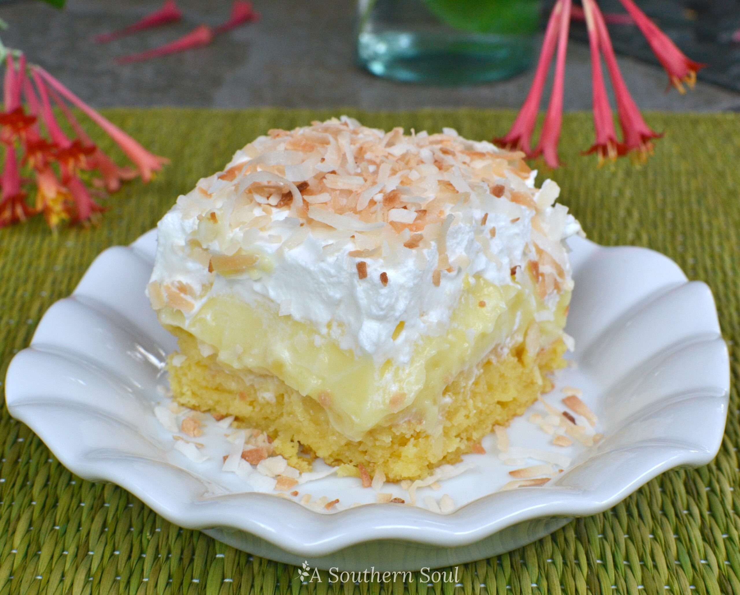 Pineapple Coconut Poke Cake is loaded with tropical flavor and easy to make. With a box cake mix, pudding, pineapple, cooking and whipped cream you can make this cake!