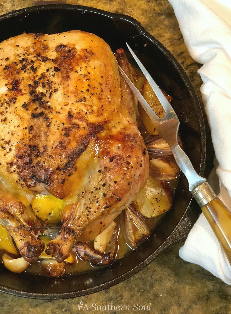 lemon roast chick onions garlic in a cast iron skillet