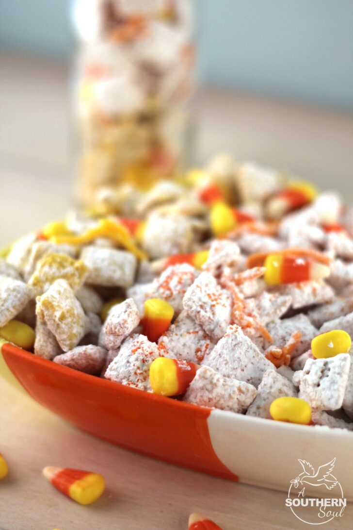 Candy corn Muddy Buddy snack mix is loaded with sweetness. It's a crunchy treat that everyone will love.