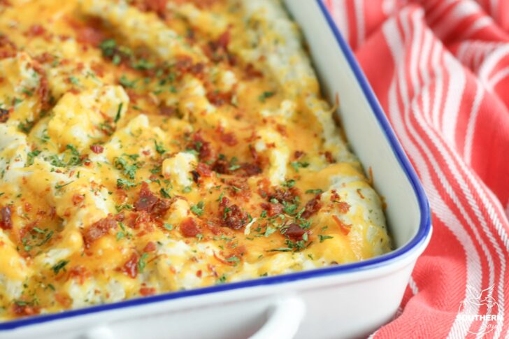 Twice baked potato casserole is a family favorite recipe. Loaded with bacon and cheese, it's a great side dish for the holidays or a week night meal.