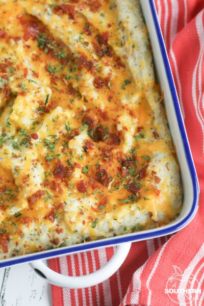Twice baked potato casserole is a family favorite recipe. Loaded with bacon and cheese, it's a great side dish for the holidays or a week night meal.