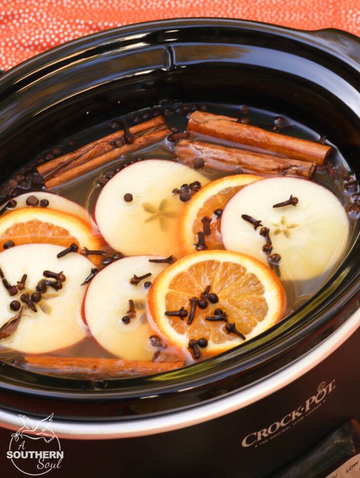 Crock Pot Mulled Cider with brown sugar, cinnamon, cloves, apples and oranges should be named the official drink of fall!