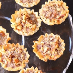 Pecan Pie Tart Bites are a fun little treat loaded with all the flavor of a regular slice of pie! Easy to make with the help of store bought phyllo cups, this dessert comes together in less than 15 minutes.