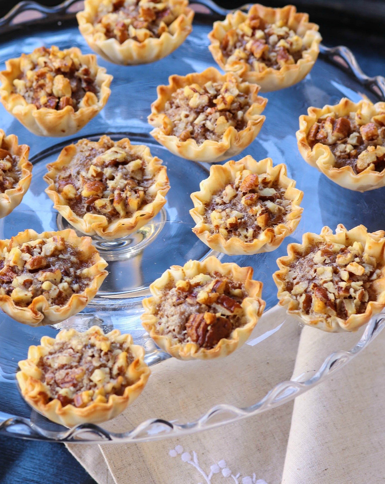 Pecan Pie Tart Bites are a fun little treat loaded with all the flavor of a regular slice of pie! Easy to make with the help of store bought phyllo cups, this dessert comes together in less than 15 minutes.