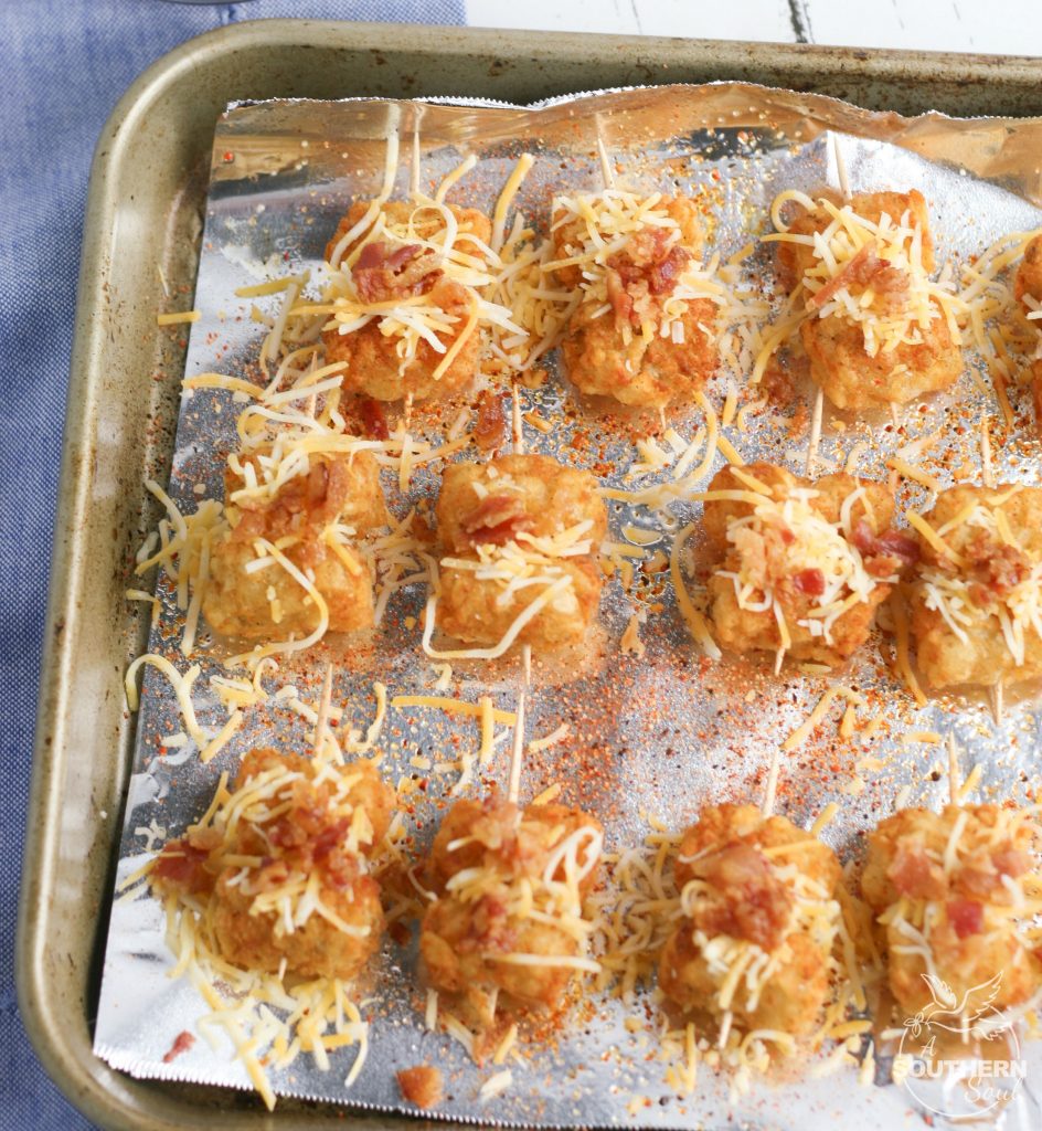 Tater Tots made into loaded little appetizer bites are a great appetizer or snack. Topped with cheese & bacon then dipped into creamy sour cream, they become a savory treat everyone will love.