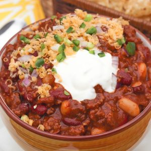 Rich, meaty chili made with Bloody Mary mix and two kids of beans is loaded with flavor that's sure to make the chili lovers in your life smile!