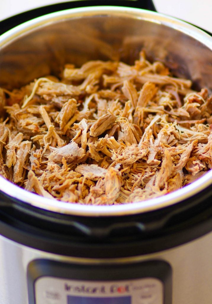 Pulled Pork cooked in the Instant Pot is tender and juice. It's then turned into nachos loaded with cheese, beans, corn, peppers, avocado, BBQ sauce and sour cream for a dish that is out of this world!