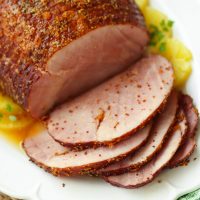 Crock Pot Sweet & Savory Ham is cooked in the slow cooker with pineapple juice, apricot preserves and whole gain mustard. It's the perfect dish to serve on any holiday and great for covered dish supper, picnics and makes wonderful sandwiches!