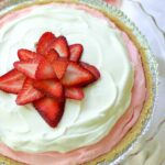 Strawberry Jello Pie made with fresh whipped cream and strawberry jello is an easy to make dessert that is cool and delicious. It's perfect for the holidays, potluck or covered dish suppers or a weeknight meal.