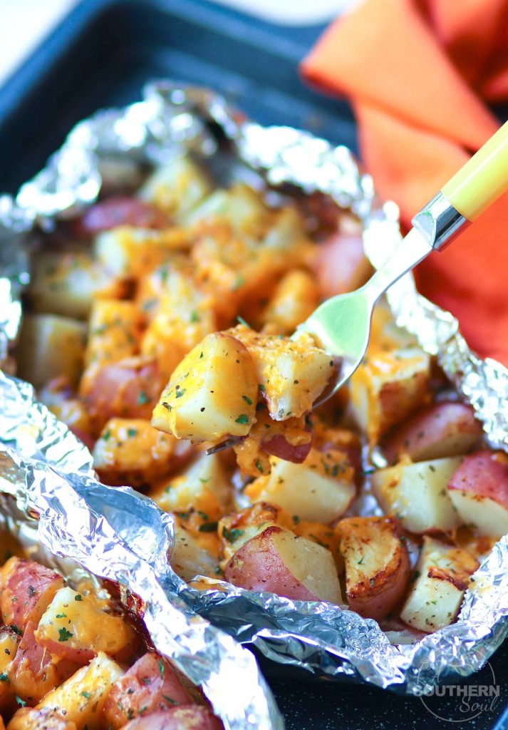 Red potatoes flavored with ranch seasoning then cooked on the grill in foil packets are loaded with cheese for a side dish that is perfect for any cookout or BBQ!