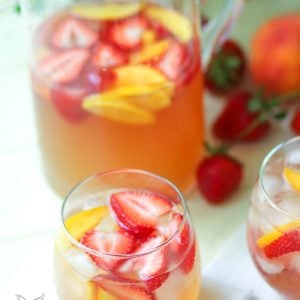 Rose sangria flavored with peach schnapps, peach juice with fresh fruit is a cool drink that's excellent for summertime!,