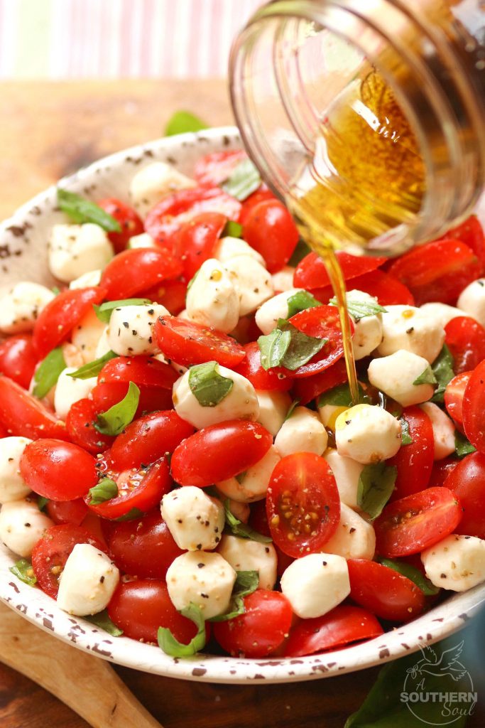 Garden fresh tomatoes and herbs tossed with mozzarella, along with basil in a two ingredient dressing of olive oil and balsamic vinegar might just be the most simple, most delicious salad ever!