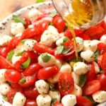 Garden fresh tomatoes and herbs tossed with mozzarella, along with basil in a two ingredient dressing of olive oil and balsamic vinegar might just be the most simple, most delicious salad ever!