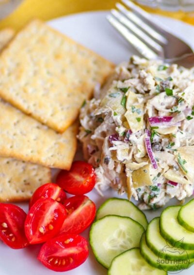 Artichoke Chicken Salad made with shredded white meat chicken, artichokes, capers and red onion tossed in a creamy, light, fresh dressing is a great new twist on a classic recipe!