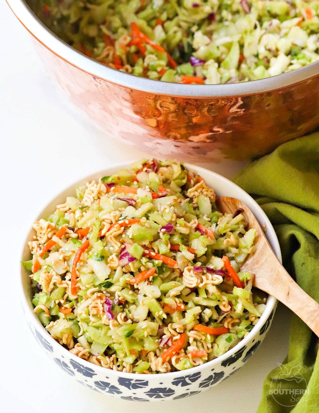 Ramen Broccoli Slaw made with toasted, packaged noodles, broccoli, carrots, green onion and a savory sweet dressing is a delicious side dish. Perfect for a weeknight meal, cookout, pot luck or covered dish supper.