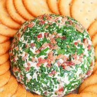 Jalapeno Popper Cheese Ball made with cream cheese, jalapenos, cheddar cheese, ranch seasoning, bacon and chives is an easy to make crowd please appetizer!