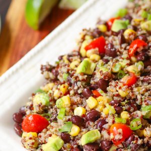 Mexican Quinoa Salad made with quinoa cooked in the instant pot then tossed with tomatoes, black beans, corn, avocado and green onions. A slightly spicy dressing turns the ingredients into a tasty side dish or salad.