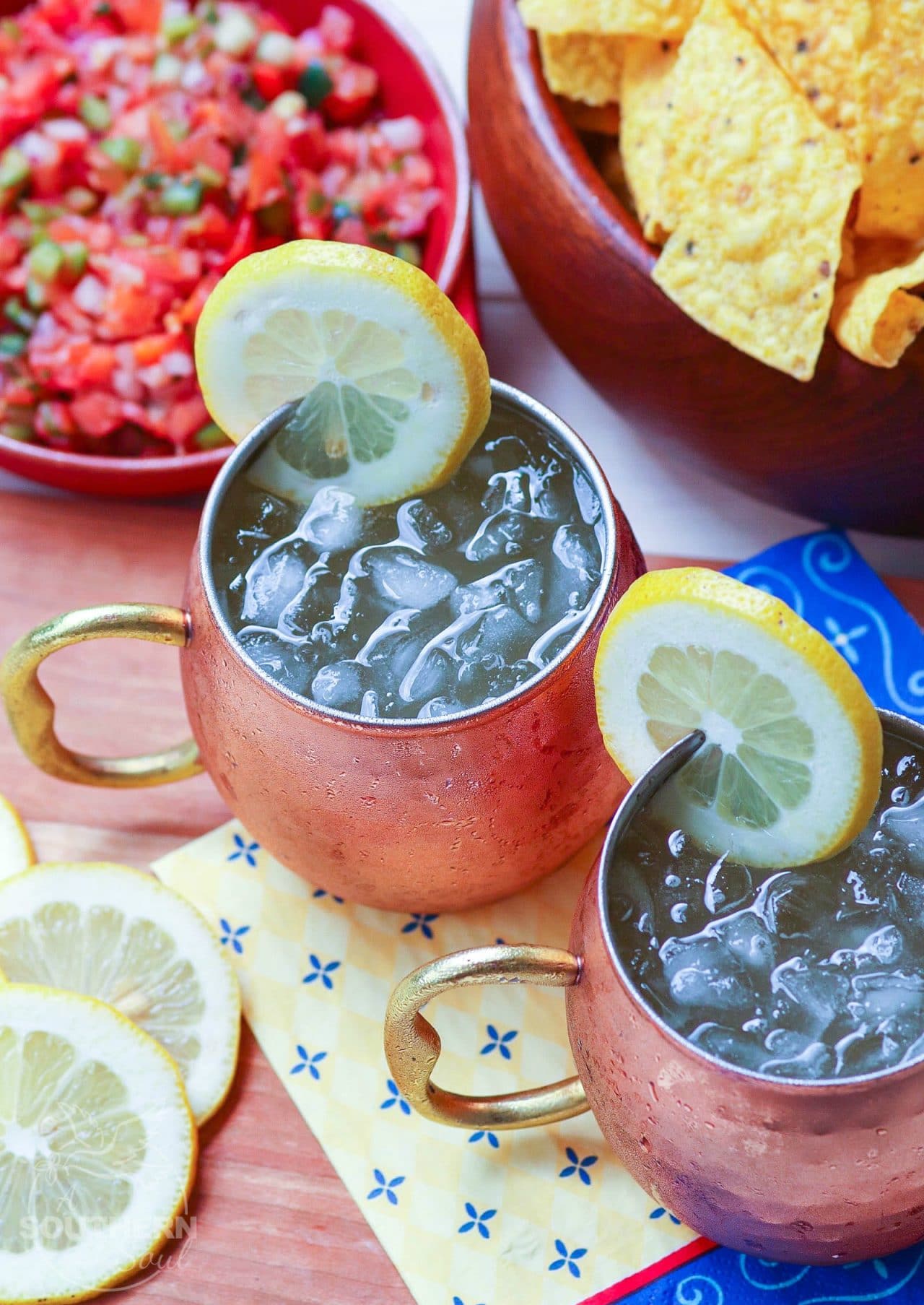 Refreshing lemon shandy made with your favorite beer, lemonade and a twist of lemon is a great drink for summer, tailgating, game day or backyard cookouts.