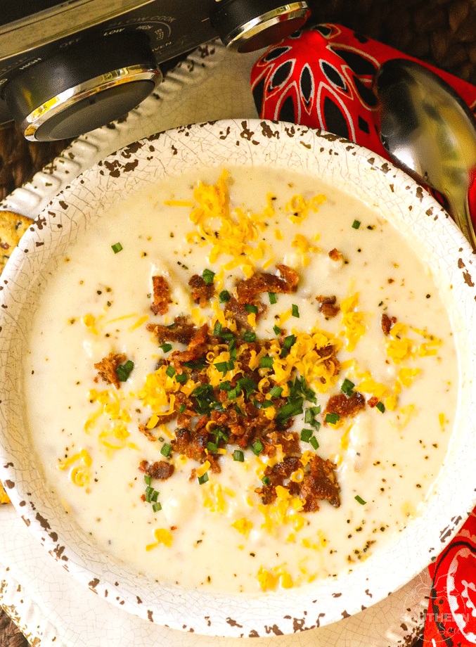 Rich, creamy potato soup made in the crockpot is topped it with cheese, bacon and chives just like a loaded baked potato.