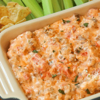 Warm dip made with crumbles sausage, cream cheese, pimento cheese along with green chilies and tomatoes is the perfect dip for parties, game day or tailgating!