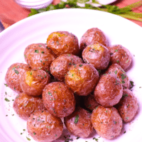 Air Fryer Baby Potatoes are tossed in butter, salt, pepper and parsley for a side dish that's irresistible. Crispy on the outside and soft on the inside these easy to make potatoes are great served for breakfast, lunch or dinner!
