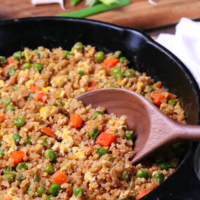Cauliflower Fried Rice is a low carb version of your favorite Chinese take out dish. Made with cauliflower, eggs, carrots, and peas, it's seasoned with soy sauce and garlic all ready in less than 20 minutes!