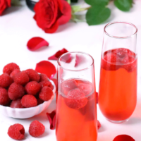 Raspberry Mimosas made with fresh berries, raspberry sorbet, grenadine and prosecco made a festive drink for any occasion!