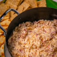 Crock Pot Reuben Dip is so easy to make with just a few ingredients. Make with corned beef, sauerkraut, thousand island dressing and swiss cheese just like the famous, classic sandwich!