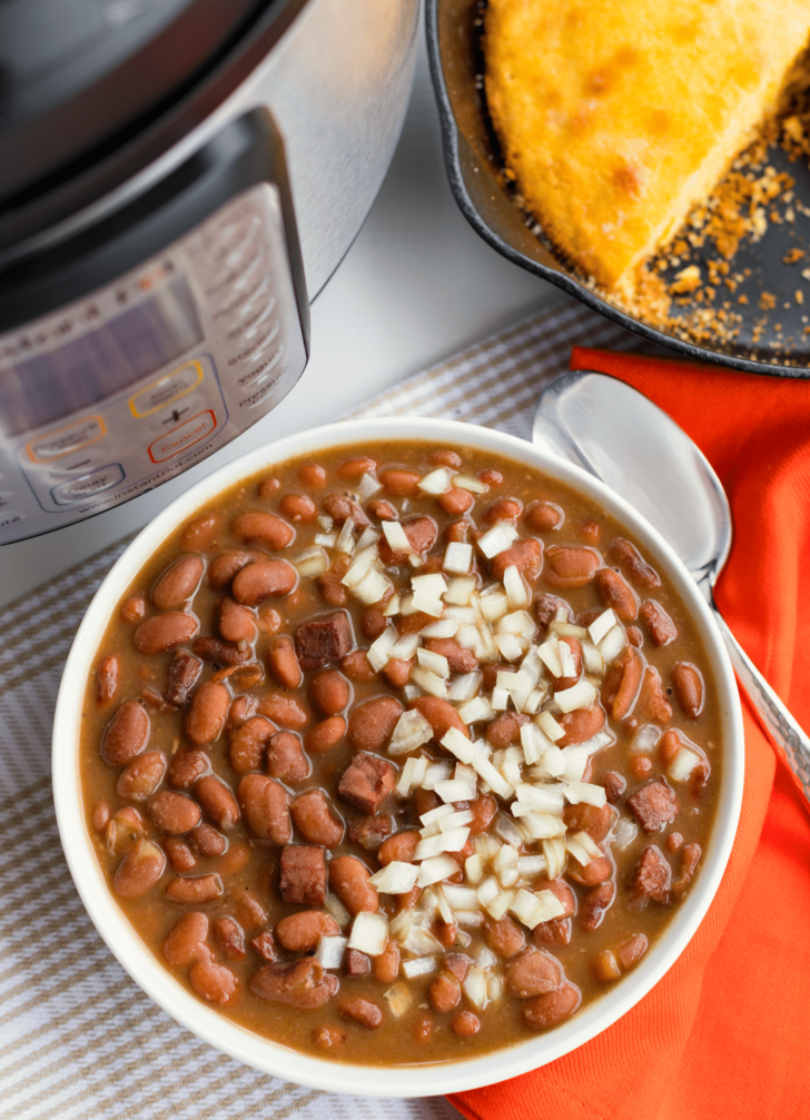 Instant Pot Pinto Beans are so easy to make! Seasoned with ham, onion and garlic then cooked in vegetable stock, this no-soak recipe is great as a main or side dish.