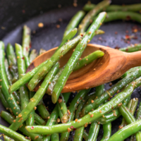 Skillet Green Beans made with garlic, lemon and red pepper is the ideal side dish for any meal! Simple and ready in 15 minutes!
