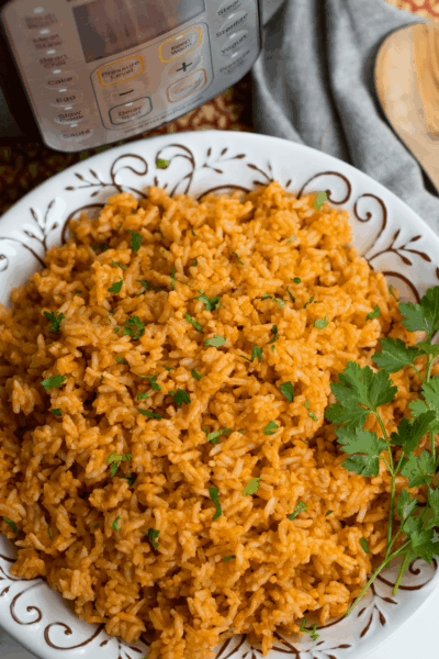 Instant Pot Mexican Rice made with white rice, tomato sauce, onions, cumin and chili powder is a great side dish for a weeknight meal or your next fiesta!