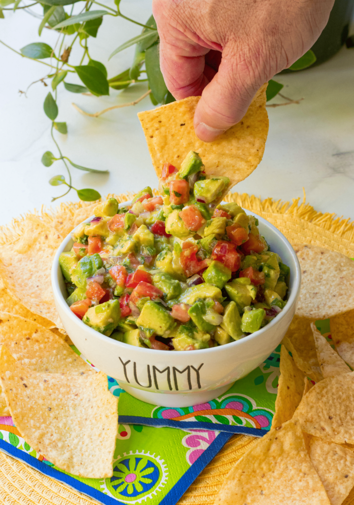 Avocado Salsa made with fresh avocado, tomatoes, jalapenos, red onion then tossed in a light dressing of lime, olive oil, garlic powder, salt and pepper. This is the perfect dip to serve at your next party and it's also delicious served with fish or chicken.
