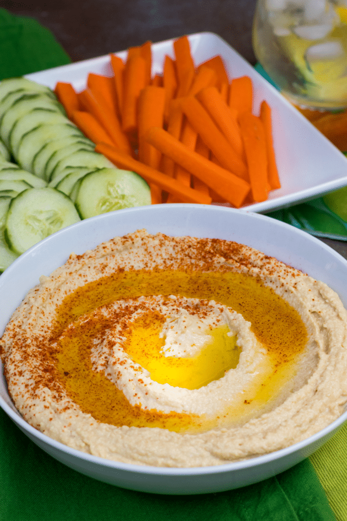 Roasted Garlic Hummus is so delicious and easy to make. Made with olive oil, roasted garlic cloves, chickpeas, lemon juice, tahini, salt and red pepper flakes that are blended together until silky smooth.