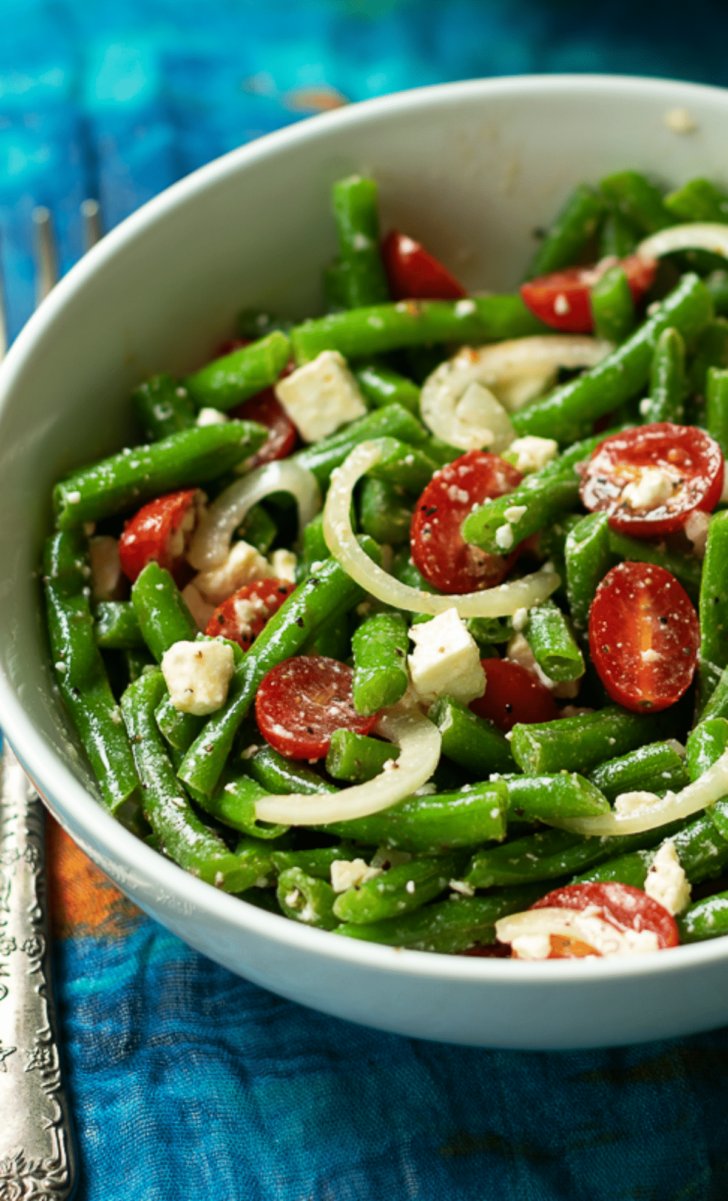 Green Bean Salad made with fresh bean, tomatoes, onions and feta cheese, tossed into a light lemony dressing is the perfect side dish for any meal!