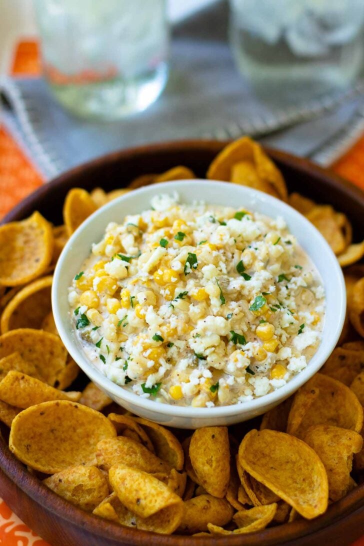 Mexican Corn Dip made with white and yellow corn, mayonnaise, sour cream, cojita cheese, canned green chilies, chicli powder, garlic, salt and cilanto. A yummy, easy to make appetizer servd with corn chips or tortillas.