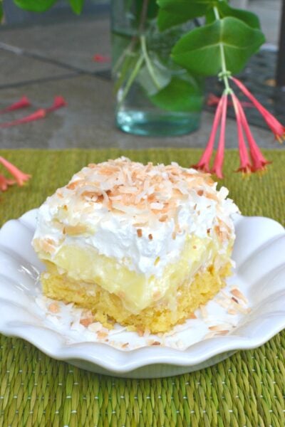 Pineapple Coconut Poke Cake is loaded with tropical flavor and easy to make. With a box cake mix, pudding, pineapple, cooking and whipped cream you can make this cake!