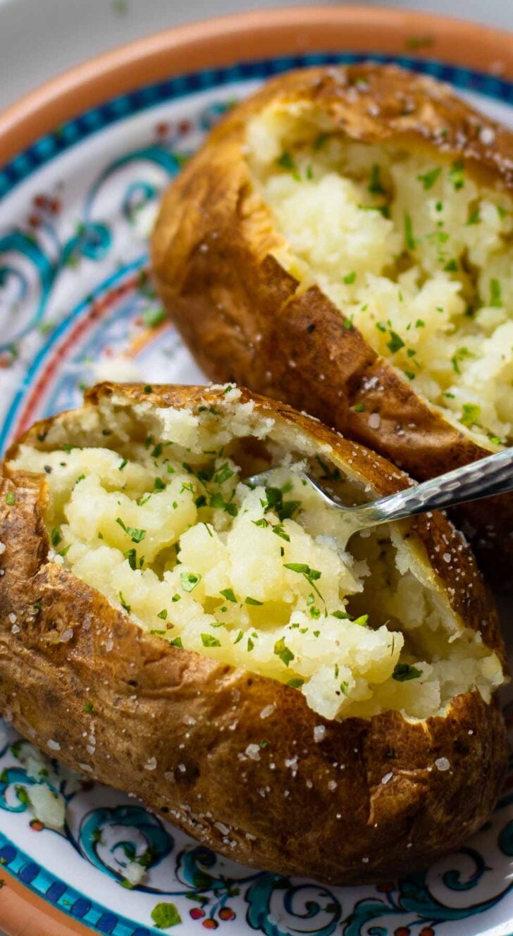 Baked Potatoes made in the Air Fryer are tender and fully on the outside with a crispy skin that makes them irresistible. Easy to make, just add your favorite toppings like butter, chives, sour cream, salt and pepper.