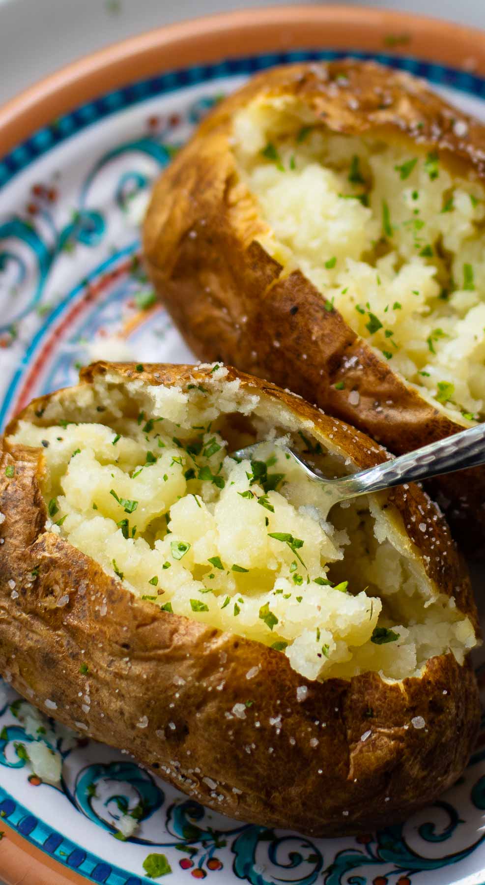 Baked Potatoes made in the Air Fryer are tender and fully on the outside with a crispy skin that makes them irresistible. Easy to make, just add your favorite toppings like butter, chives, sour cream, salt and pepper.