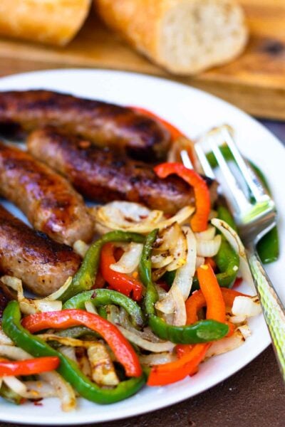 This classic combination of Grilled Sausage, Peppers and Onions is totally easy to make and delicious. Made with mild Italian sausage, sliced red and green bell pepper and yellow onions seasoned with salt and pepper and cooked on the grill.