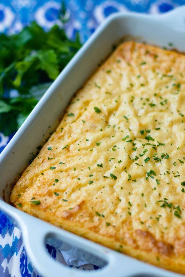 Smoked Gouda Cheese Grits Casserole is full of deep, rich flavors. Made with quick cooking grits, shredded smoked gouda cheese, butter, half and half, red pepper flakes and salt. The perfect side dish for grilled meats and fish or anytime you need the ultimate side dish.
