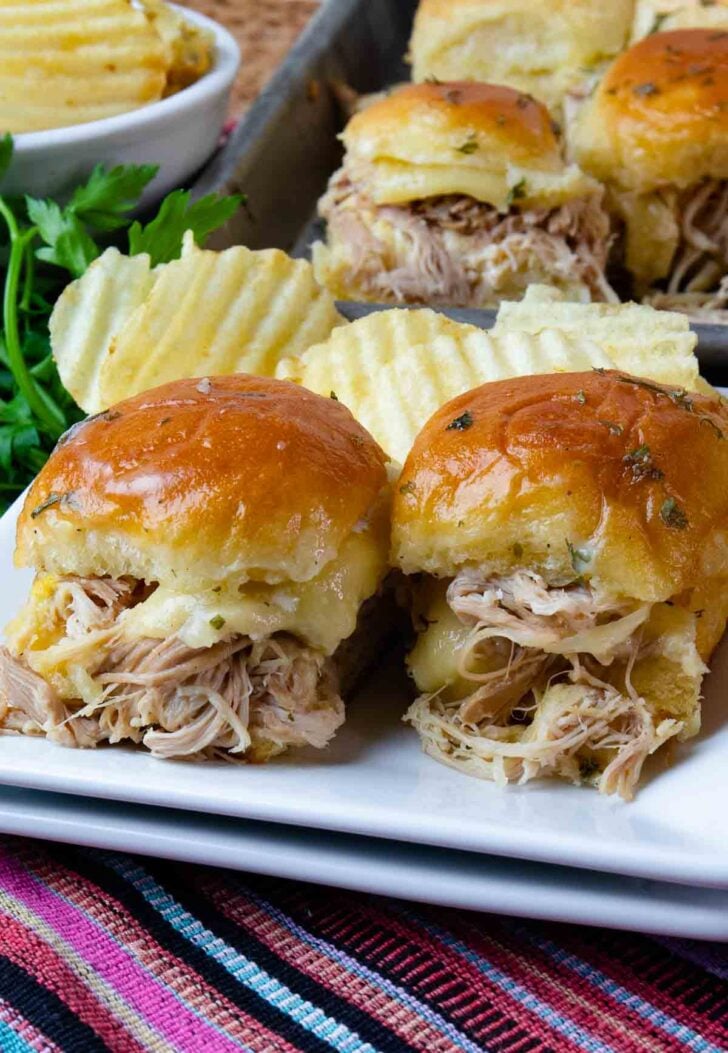 Mississippi Chicken cooked in the crock pot made into sliders with cheese and baked in the voen.