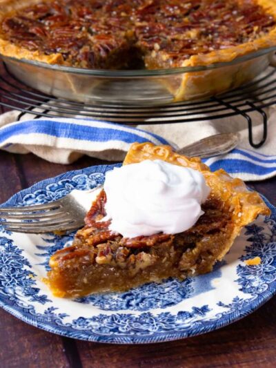 Sliced Maple Bourbon Pecan Pie on cooling rack and on plate.