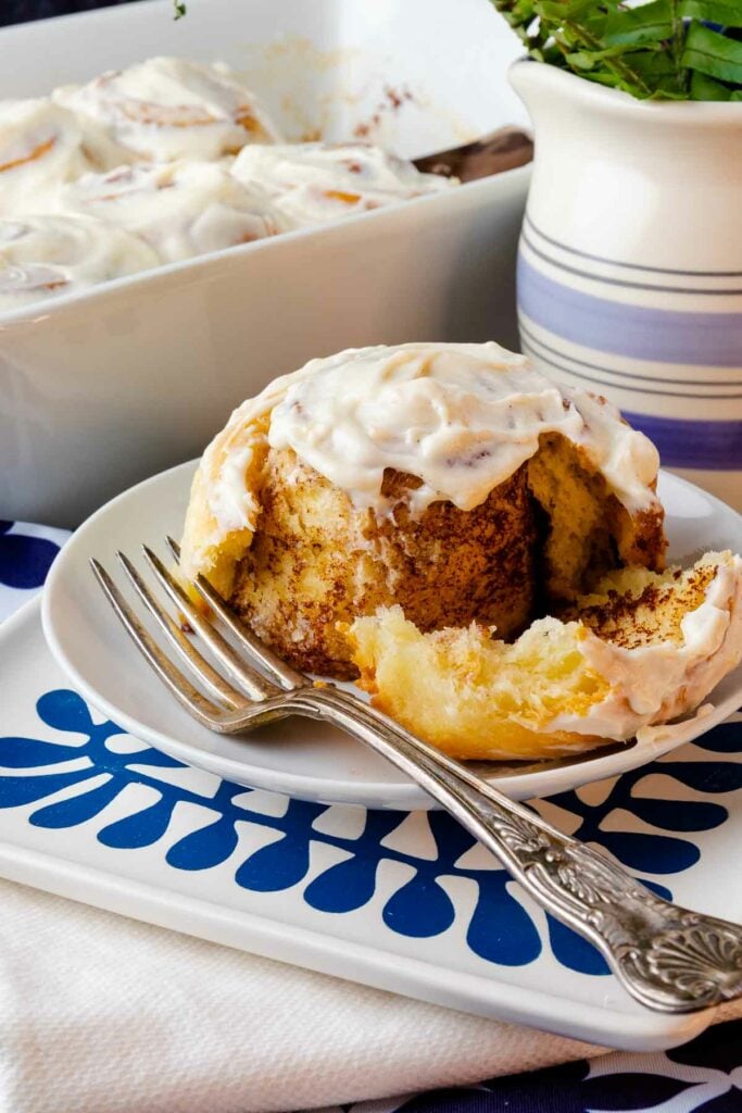 Easy Cinnamon Rolls cut with a fork are loaded with cinnamon and brown sugar.