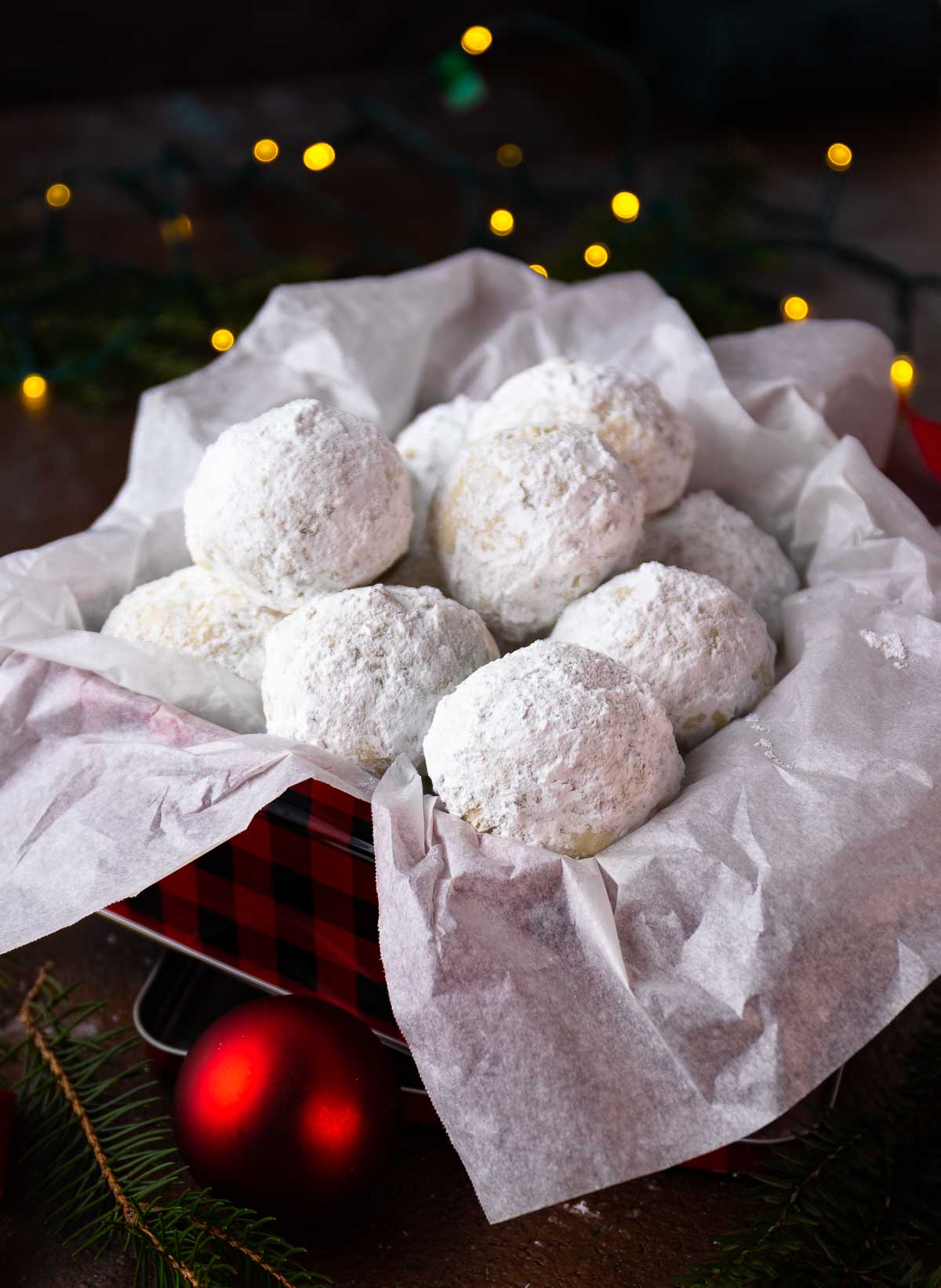 Snowball Cookies in a metal tin for gift giving at Christmas.
