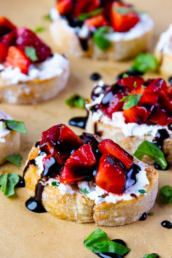 Strawberries and goat cheese with herbs on toast with balsamic drizzle.
