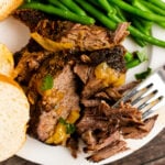 Busy Day Pot Roast on a white plate with a fork and green beans