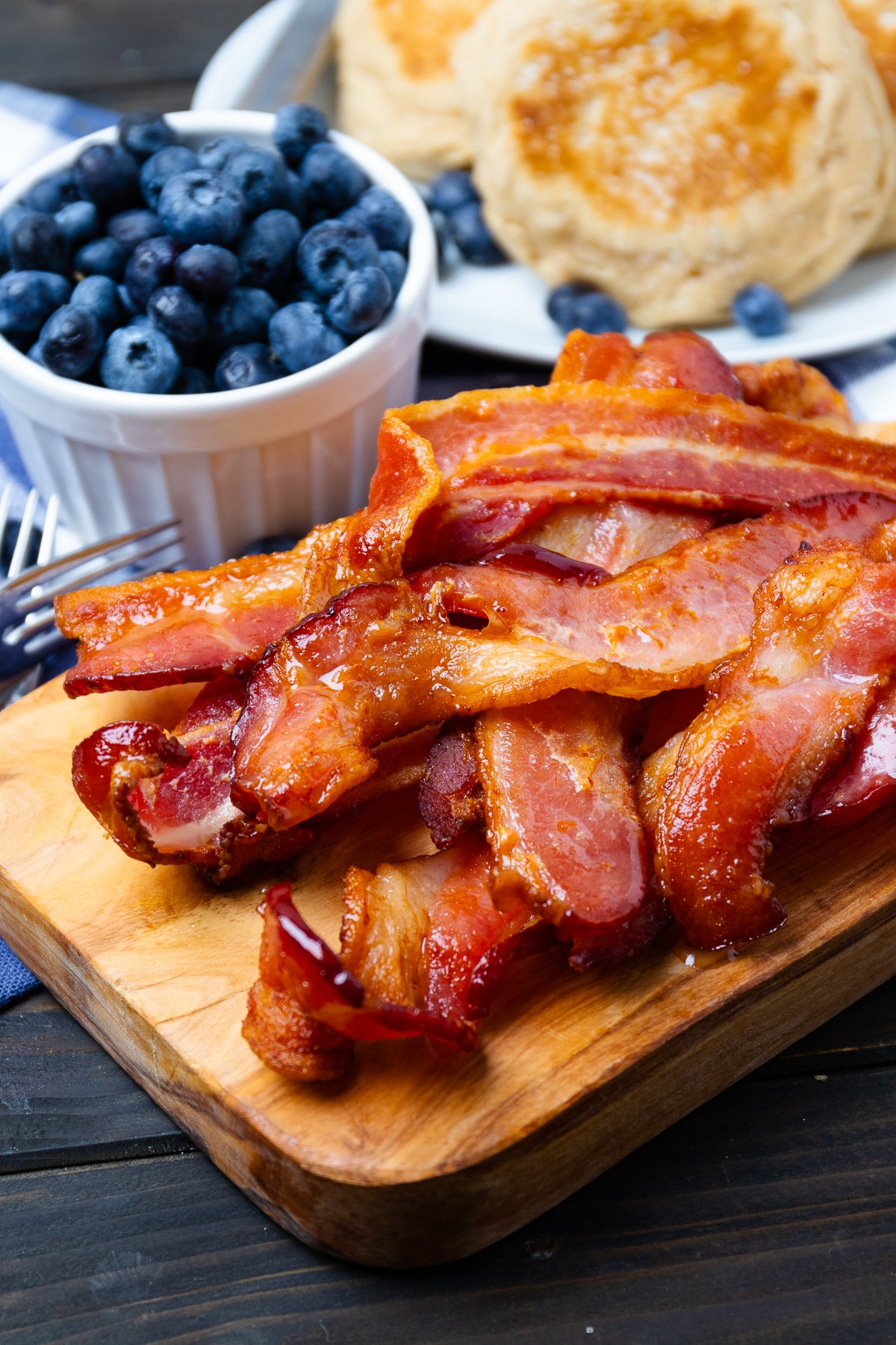 Air fried bacon on a wooden board.